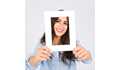 smiling-woman-holding-frame-in-front-of-face_23-2147813611